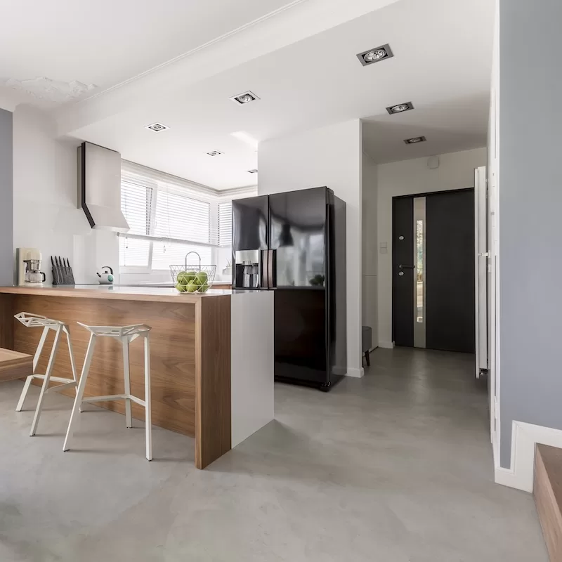 Dining room, kitchen and entrance in contemporary family house with minimalist gray design, colorful accents and wooden furniture
